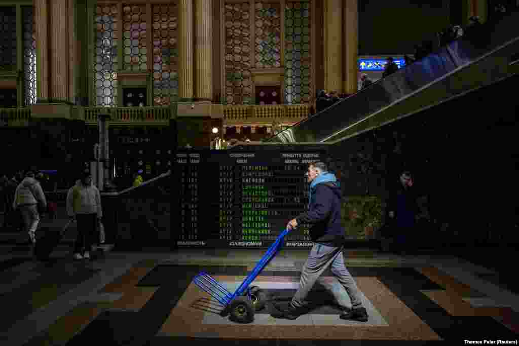A man pushes a trolley through the hall of the main train station in the Ukrainian capital, Kyiv.