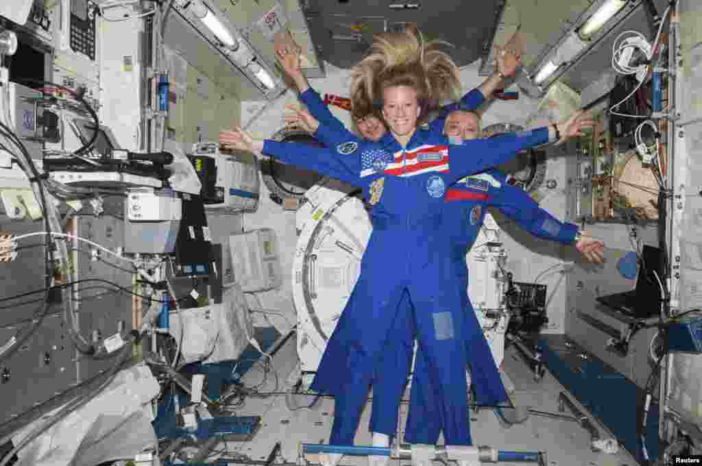 NASA astronaut Karen Nyberg, Russian cosmonaut and mission commander Fyodor Yurchikhin (right), and European Space Agency astronaut Luca Parmitano pose for a photo in the Kibo laboratory of the International Space Station.