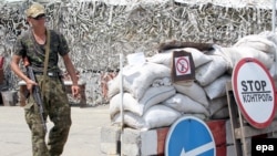 A pro-Russian separatist mans a checkpoint 25 kilometers from the rebel stronghold of Donetsk on July 23.