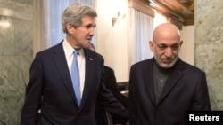 Afghan President Hamid Karzai (right) with US Secretary of State John Kerry (file photo)