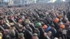 People cheer as they listen to police officers from Lviv who have joined the antigovernment protests during a rally on Independence Square in Kyiv on February 21.