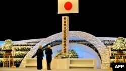 Japanese Emperor Akihito (right) and Empress Michiko pay their respects before an altar in Tokyo during a memorial service for the victims of the March 11, 2011, earthquake and tsunami.
