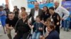 Armenia - British singer Elton John and Armenian President Armen Sarkissian pose for a photograph with children in Yerevan, 27 May 2018.