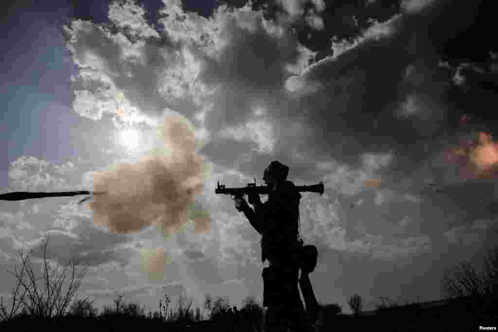A Ukrainian soldier uses a grenade launcher during a training exercise at an undisclosed location in eastern Ukraine.