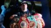 Боксьорът Олександър Усик със своите шампионски колани от WBA, IBF, WBO и IBO позира след пресконференция в Киев, 1 август 2018.