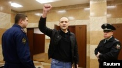Opposition leader Sergei Udaltsov gestures as he arrives at the Moscow City Court building on February 18.