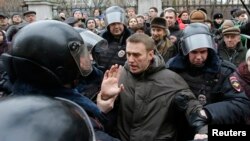 Russian police detain opposition leader Aleksei Navalny outside a courthouse in Moscow on February 24.