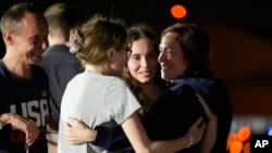 Alsu Kurmasheva (right) hugs her daughters, Bibi and Miriam, as her husband, Pavel Butorin, looks on at Joint Base Andrews outside of Washington, D.C., following her release as part of a 24-person prisoner swap between Russia and the United States, on August 1.
