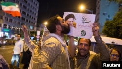 A supporter of Ebrahim Raisi kisses his poster during a presidential campaign rally in Tehran in 2017. The conservative cleric lost his bid for the presidency the last time around, but is seen as a front-runner in this year's vote.