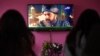 A family watches the Turkish drama series Dirilis: Ertugrul on Pakistani TV during the holy month of Ramadan in Islamabad.