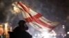 A protester waves a Georgian flag during protests in Tbilisi on December 7, 2024. 