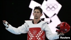 Iran's Mohammad Bagheri Motamed celebrates winning the silver medal in the under-68-kilogram taekwondo competition at the London Olympic Games.