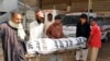 Volunteers handover the body of convicted hijacker to relatives in Hyderabad on May 28.