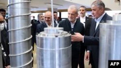 President Masud Pezeshkian (second right) and Atomic Energy Organisation of Iran chief Mohammad Eslami (right) on the National Day of Nuclear Technology in Tehran on April 9