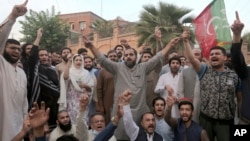 Supporters of Imran Khan's party chant anti government slogans in Peshawar on March 14 while protesting the police operation against the former Pakistani prime minister.