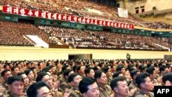Military officers celebrate the second successful nuclear test at the Pyongyang Indoor Stadium on May 26