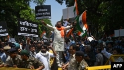 Protesters in New Delhi hold placards during a protest march towards the Pakistan High Commission condemning the Pahalgam attack on April 24.