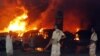 Pakistani paramilitary soldiers stand guard as trucks and tankers carrying supplies bound for NATO forces in Afghanistan burn following the overnight attack in Shikarpur.