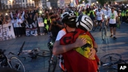 Serbian university students who cycled from Novi Sad, Serbia, hug on April 15 as they arrive in in Strasbourg, France, the heart of the European Union.