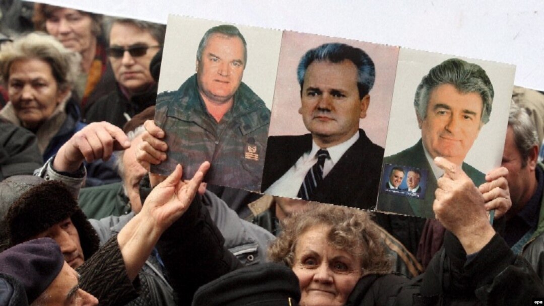 Nationalists hold up pictures of Ratko Mladic, Radovan Karadzic, and Slobodan Milosevic at a rally in 2007. Now they are rallying for Libya's Muammar Qaddafi.