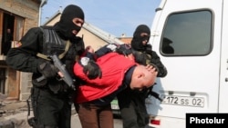 Armenia - Security forces detain a man in a raid on a house in Yerevan's Nork district, 25Nov2015.
