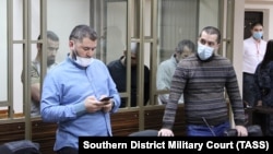 Riza Omerov (left), his father, Enver Omerov, and Ayder Dzhepparov (in the background) appear in court in Rostov-on-Don on January 12.