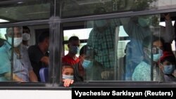 People wearing protective face masks inside a bus in Ashgabat, the capital of Turkmenistan where the coronavirus officially does not exist. 