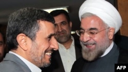 Then-President Mahmud Ahmadinejad (left), who consistently cast doubt on whether the Holocaust ever took place, greets President-elect Hassan Rohani in Tehran in mid-June.
