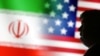 FILE PHOTO: Illustration shows 3D-printed miniature model of U.S. President-elect Donald Trump, and U.S. and Iran flags