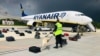 Security checks passengers' luggage after Raman Pratasevich's Ryanair flight was forced to land in Minsk in May 2021.