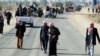 Armed relatives and tribe members protect the road during a funeral procession for deputy Ayfan Saadun al-Essawi of the Al-Iraqiyah bloc in the western town of Fallujah on January 16. Essawi was killed by a suicide bomber.