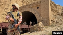 Pakistani soldiers stand at a tunnel where a train was attacked by separatist militants in Balochistan on March 15. Pakistan's border regions near Afghanistan have seen an uptick in insurgent violence in recent years.