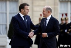 Emmanuel Macron îl întâmpină pe Olaf Schilz, premierul Germaniei.