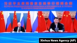 Vladimir Putin și Xi Jinping într-o videoconferință pe 28 iunie 2021.