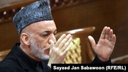 Afghan President Hamid Karzai makes his opening address to the loya jirga in Kabul.