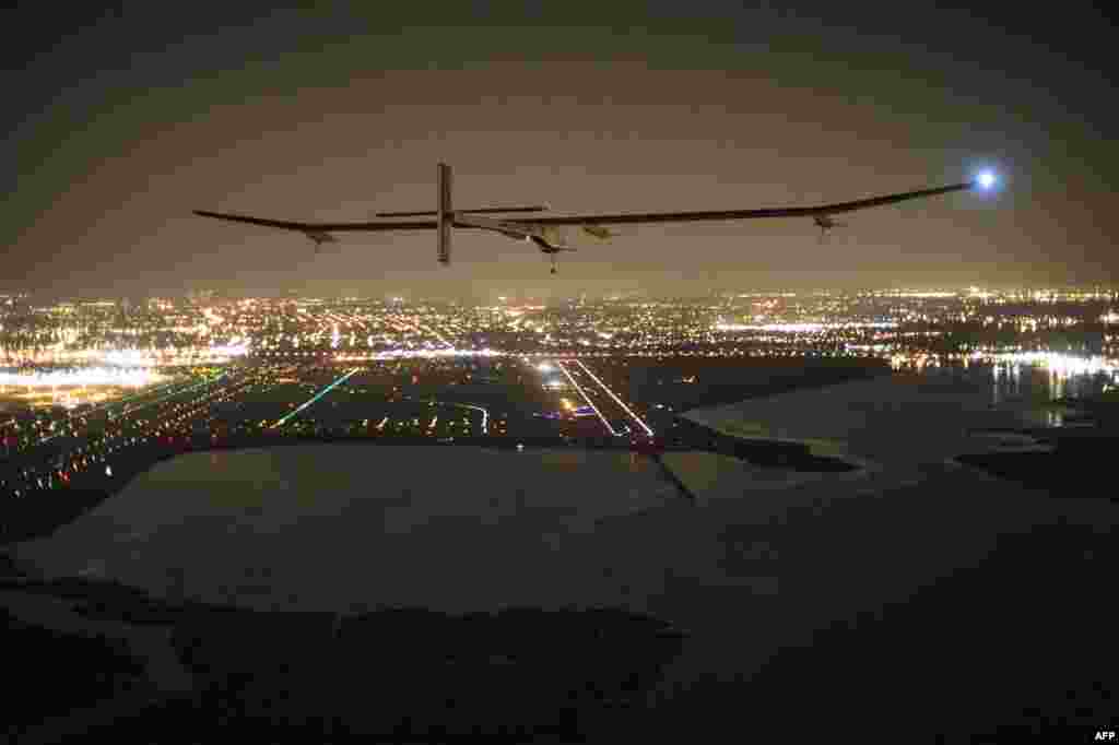 A handout photo of the "Solar Impulse HB-SIA" aircraft with pilot Andre Borschberg aboard as it approaches its final destination of JFK airport in New York in what Borschberg called a "huge success for renewable energy." (AFP/SolarImpulse/Jean Revillard)