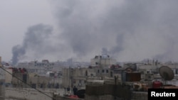 Smoke rises from a Damascus suburb as fighting rages in parts of the Syrian capital on January 29.