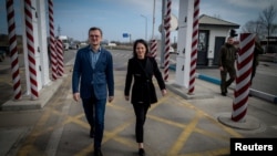 Очільниця МЗС Німеччини Анналена Бербок (п) і її український колега Дмитро Кулеба перетинають пункт пропуску в Одеській області, 24 лютого 2023 року