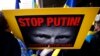 Зображення президента Росії Володимира Путіна на плакаті учасників акції протесту в столиці Австралії через два дні після збитого 17 липня російськими гібридними силами на Донбасі «Боїнга», в результаті чого загинули 298 людей. Сідней, 19 липня 2014 року