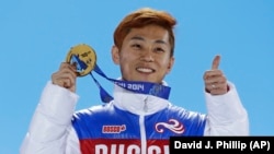 Men's 1,000-meter short-track speed-skating gold medalist Viktor Ahn of Russia holds his medal during the medals ceremony at the Winter Olympics in Sochi in February 2014.