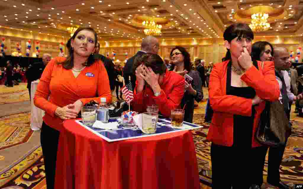 Romney supporters react to news of Obama's victory at an election-night party in Las Vegas, Nevada.