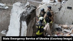 Rescue workers deal with the aftermath of a Russian drone attack on the Ukrainian city of Sumy on January 30.