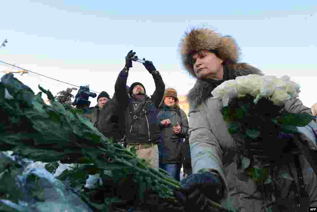 Protesters laid flowers on a monument dedicated to victims of political repression near the headquarters of the Federal Security Service (FSB) on Moscow's Lubyanka Square.