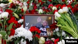 Fotografija ruskog opozicionog političara Alekseja Navaljnog i njegove supruge Julije postavljena među cvijeće na njegov grob nakon sahrane na Borisovskom groblju u Moskvi 2. marta 2024.