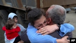 Armenia - Ethnic Armenians who fled Nagorno-Karabakh embrace upon their arrival in Kornidzor, September 26, 2023. (Stepan Poghosyan/PHOTOLUR Photo via AP)