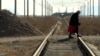 An elderly woman crosses railway tracks near the Armenian village of Yeraskh close to the border with Azerbaijan (file photo)
