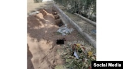 Several photos such as this one of the purported new graves at Khavaran, including two that had signs and flowers laid on them, have been posted online.