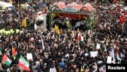 Iranians attend the funeral procession for Ismail Haniyeh in Tehran on August 1.