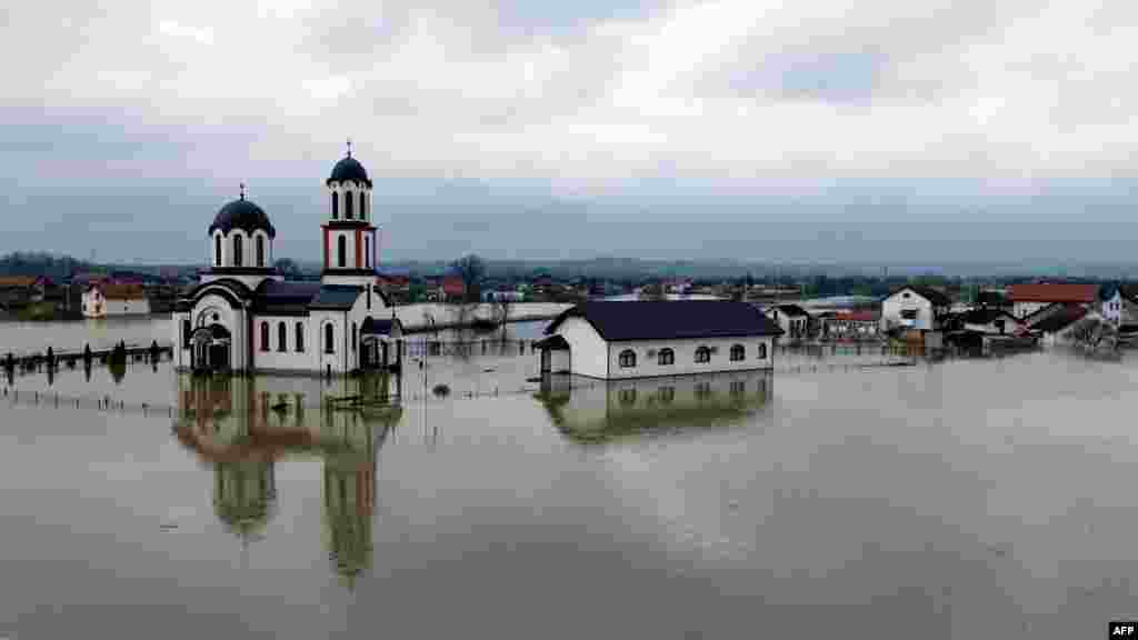 An Orthodox Christian church lies partially submerged in water in the village of Gomjenica, in northwestern Bosnia-Herzegovina following heavy rain fall in the area.