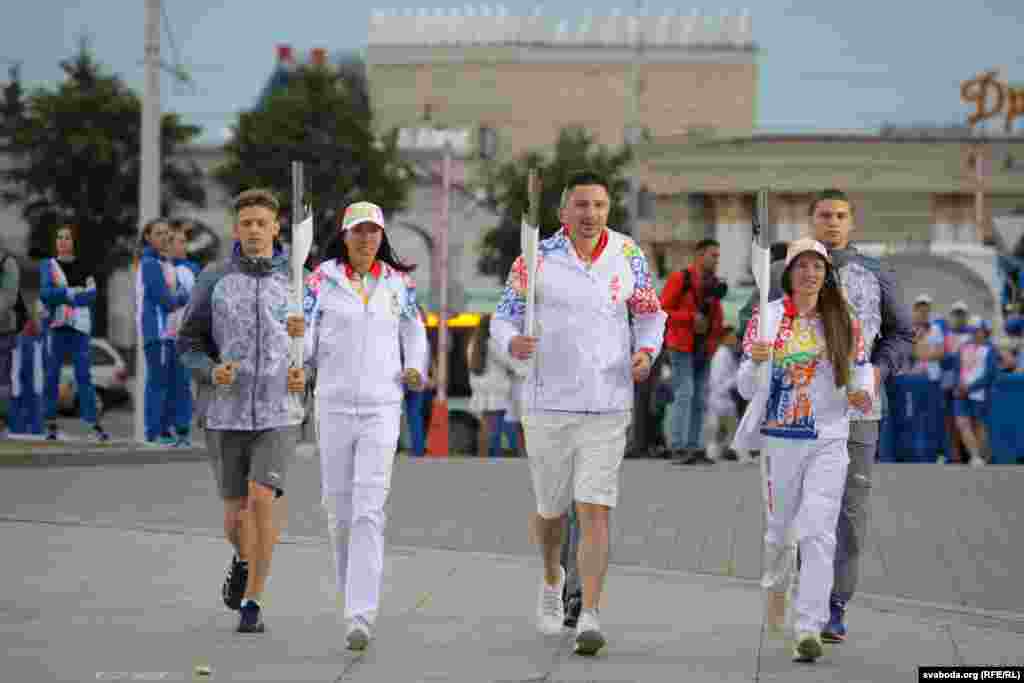 Алімпійскія чэмпіёны Дар'я Домрачава і Аляксандар Багдановіч, чэмпіёнка сьвету Марына Арзамасава рэпэтуюць вынас агню
